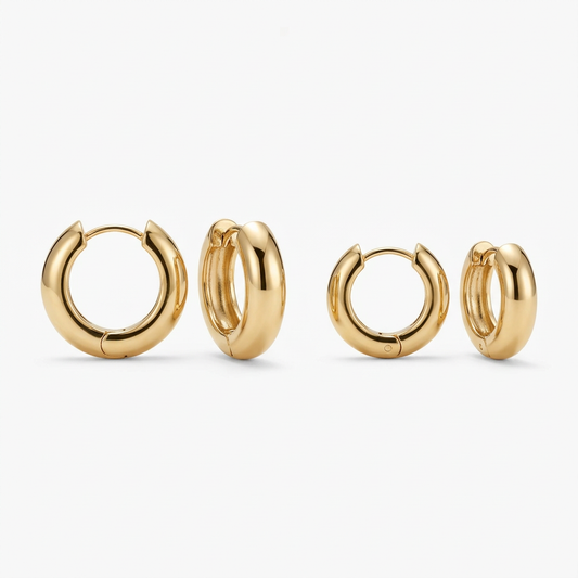 Gold tone made from Stainless Steel huggies earrings on both sizes on a white background
